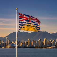 British Columbia flag waving in front of a city skyline with mountains in the background