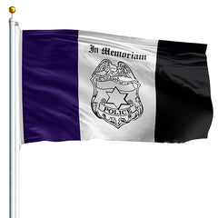 Flag with police emblem and 'In Memoriam' text on a purple, white, and black striped background.