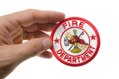 Fire Department circular patch held in hand for scale
