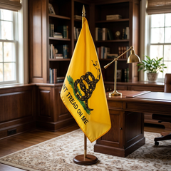 Gadsden pole-hem flag displayed on an indoor flagpole in a home office