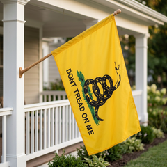 Gadsden porch flag with its sleeve slid over a wooden pole