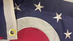Close-up of a ohio flag with stars and a red circle, featuring a grommet.
