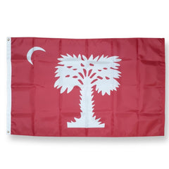 A red flag featuring a white palmetto tree and a white crescent moon, shown flat against a light gray background.